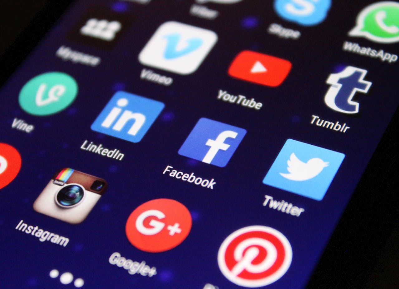 7 Tried & Tested Digital Marketing Hacks to Boost Your Business Today Close-up of a smartphone screen showing various social media app icons such as Facebook and Twitter.