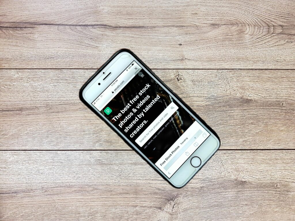 pexels photo 3721646 3721646 Top view contemporary mobile phone with opened website on screen placed on wooden table